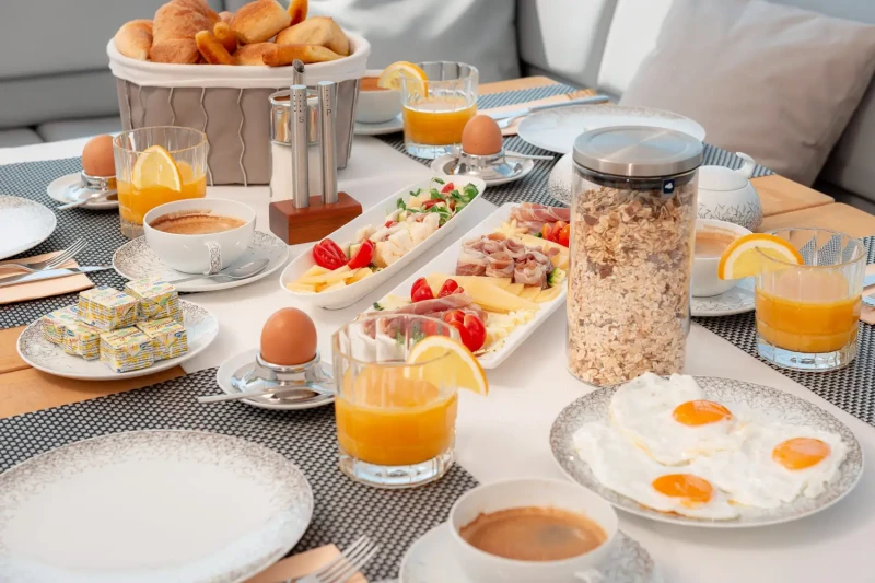 Table full of fresh food and squeezed juice on Princess 72 yacht