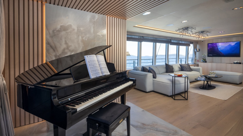 A luxurious dining area on a yacht featuring a grand piano