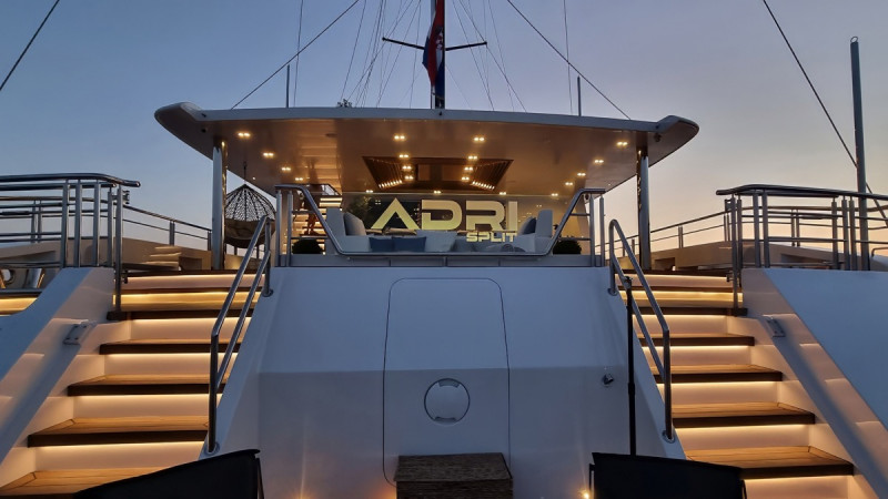 The back deck of a yacht illuminated by soft lights with