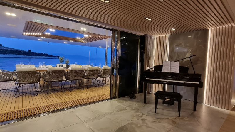 dining area on a yacht with a sleek grand piano